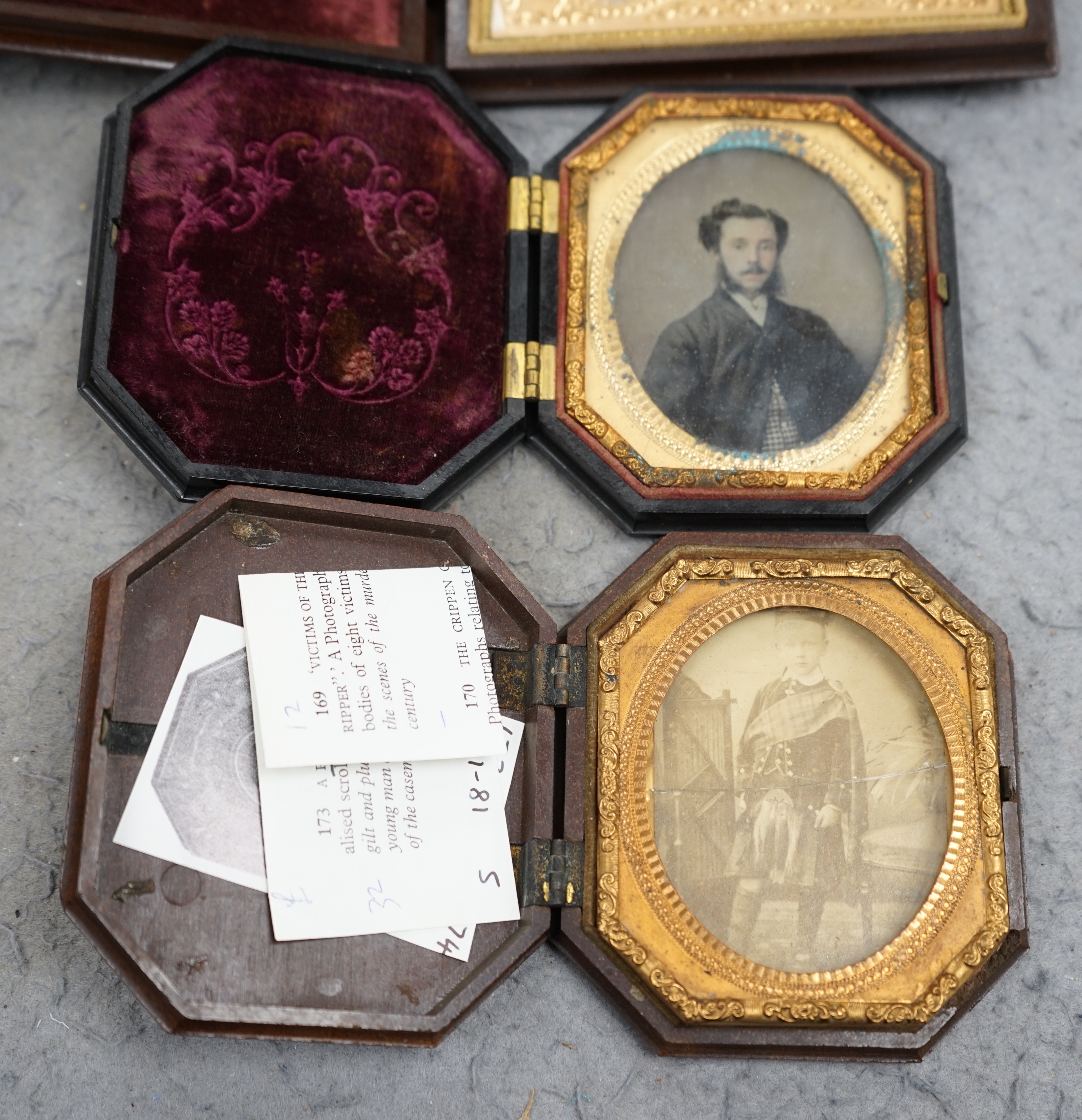 A pair of Peck & Co. sixth-plate ambrotype composite moulded cases, together with a Washington Monument phenolic cased ambrotype, largest 16 x 13cm. (3). Condition - fair